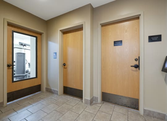 Apartments in Elk River MN_doors to the fitness center, bathroom and package room