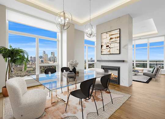 a dining room with a glass table and chairs and a fireplace at Expo, Minneapolis Minnesota