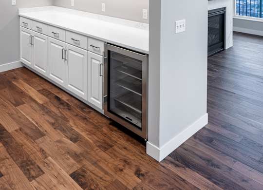 an empty kitchen with white cabinets and a wood floor at Expo, Minnesota