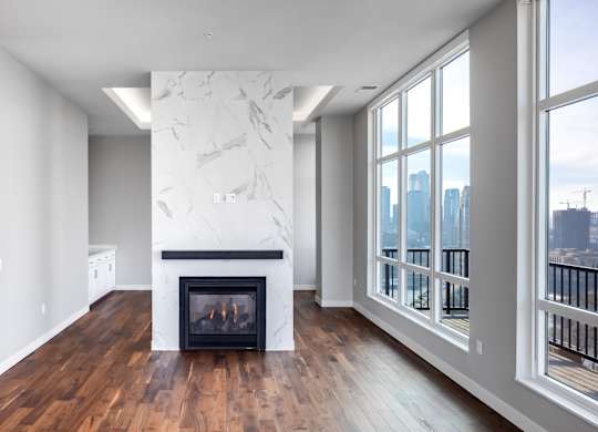 a living room with a fireplace and a large window at Expo, Minneapolis, MN 55414