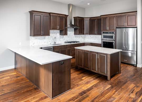 a kitchen with wooden cabinets and stainless steel appliances at Expo, Minneapolis, 55414