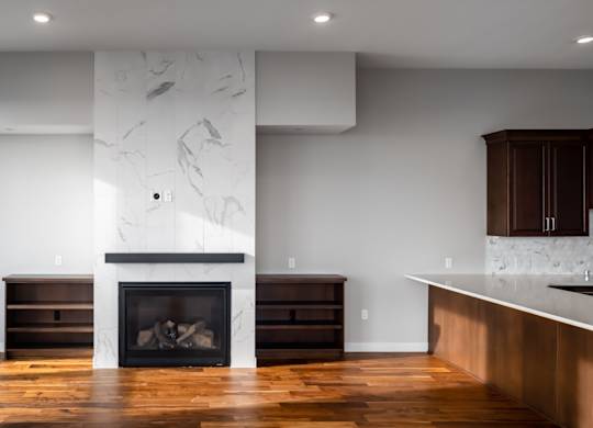 a living room with a fireplace and a large window at Expo, Minneapolis, MN