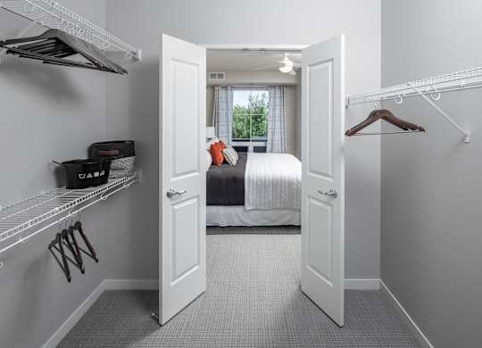 a bedroom with a bed and a closet with a door open at Expo, Minneapolis