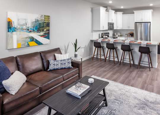 a living room with a couch and a coffee table in front of a kitchen at Expo, Minneapolis, MN