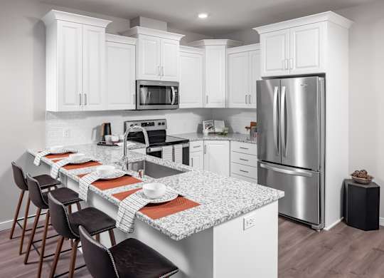 a kitchen with a marble counter top and stainless steel refrigerator at Expo, Minneapolis, 55414