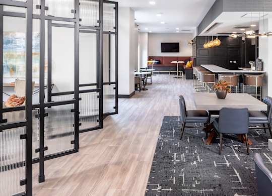 a conference room with tables and chairs and a glass door at Expo, Minneapolis, 55414