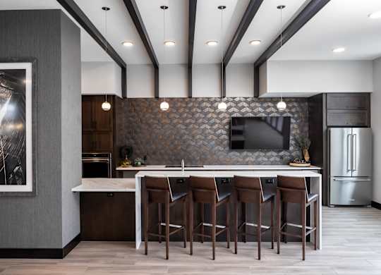 a kitchen with a large island with stools and a tv at Expo, Minnesota, 55414