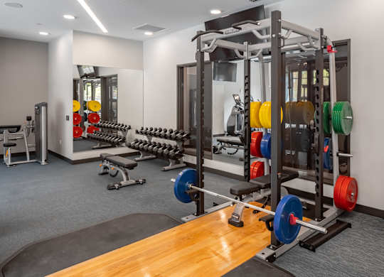 a gym with weights and other exercise equipment on a wooden floor at Expo, Minneapolis, MN