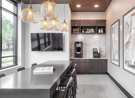 a kitchen with a long table and chairs and a large window at Expo, Minnesota