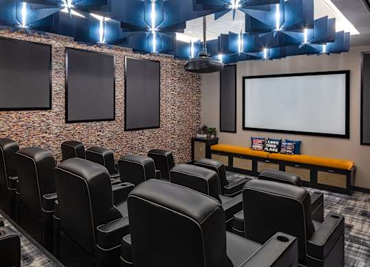 a large screening room with leather chairs and a projector screen at Expo, Minnesota, 55414