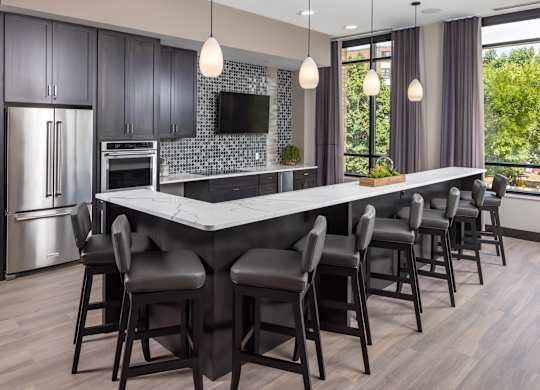 a kitchen with a large island with bar stools at Expo, Minneapolis