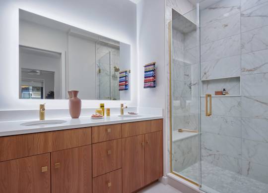 A bathroom with a marble wall and a wooden vanity. at 17 Market West, Pennsylvania