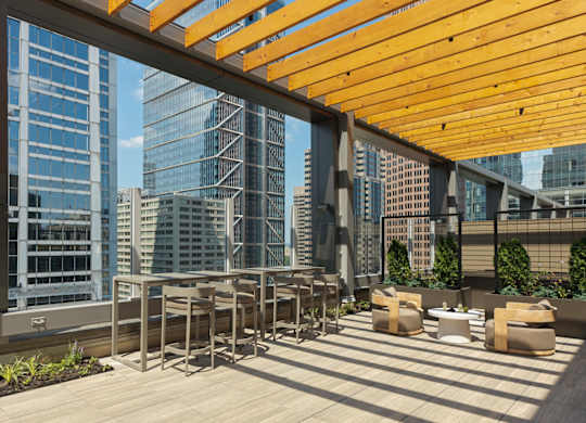 A wooden patio with a table and chairs overlooking a cityscape. at 17 Market West, Pennsylvania