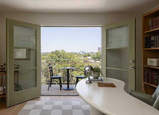 A small table with a globe on it is in the middle of a room at The PARKER on E Mulberry Apartments, San Antonio