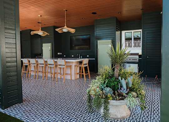A black and white checkered floor with a potted plant in the middle at The PARKER on E Mulberry Apartments, Texas