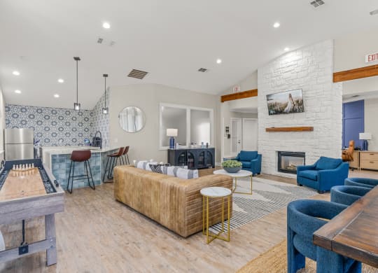 a living room with couches and chairs and a fireplace at District 2308, Texas, 76011