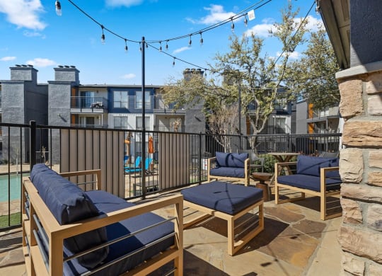 a furnished patio with a pool and lounge chairs at District 2308, Arlington 