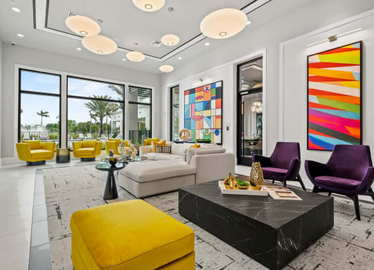 a living room with yellow furniture and large windows at Altis Grand Kendall, Miami