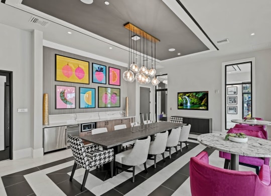 a dining room with a long table and chairs at Altis Grand Kendall, Miami