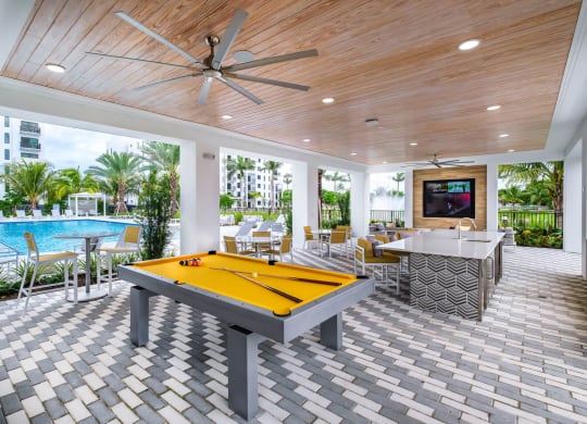 a pool room with a pool table and a bar at Altis Grand Kendall, Miami Florida