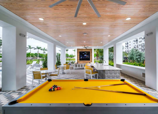 a billiards room with a yellow pool table at Altis Grand Kendall, Florida