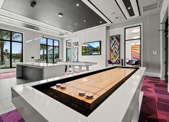 a living room with a large wooden table and a kitchen at Altis Grand Kendall, Florida 
