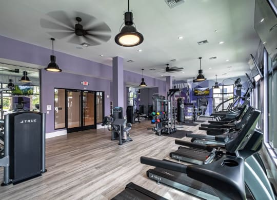 a gym with cardio machines and a ceiling fan at Altis Grand Kendall, Miami, FL 33186