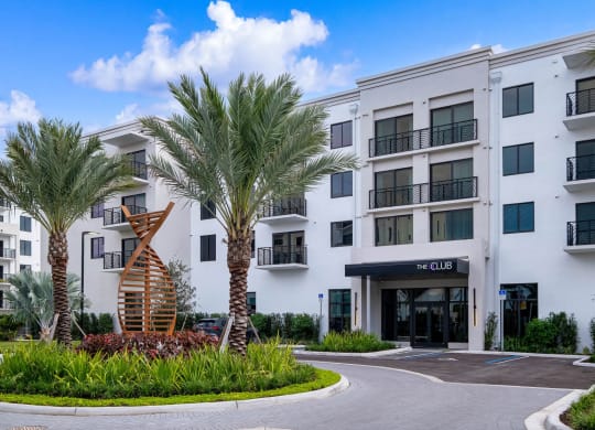 an apartment building with palm trees in front of it at Altis Grand Kendall, Miami, FL