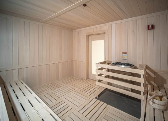 a wooden sauna with a bench and a door at Altis Grand Kendall, Miami Florida