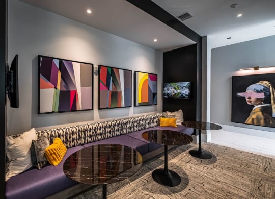 a living room with purple couch and tables at Altis Grand Kendall, Miami, FL 33186