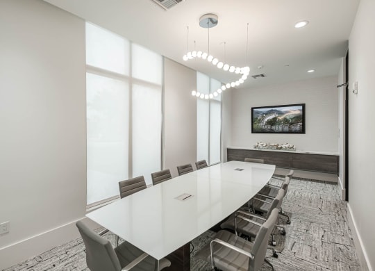 a conference room with a long white table and chairs at Altis Grand Kendall, Miami