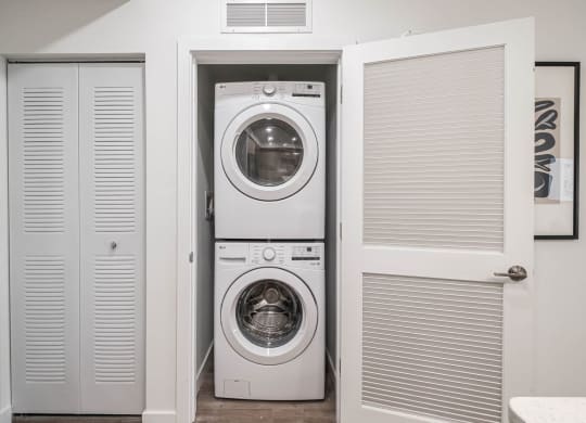 a small laundry room with a washing machine and a dryer at Altis Grand Kendall, Miami, 33186