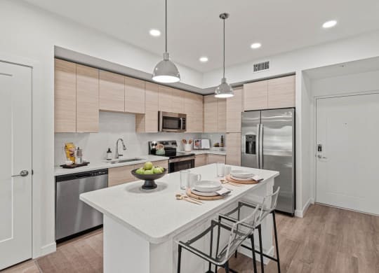 a kitchen with a large island and stainless steel appliances at Altis Grand Kendall, Miami, FL 33186