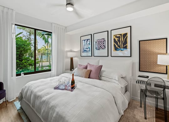 a bedroom with a bed and a desk and a window at Altis Grand Kendall, Miami, 33186