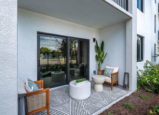 a patio with a toilet and chairs and a zebra rug at Altis Grand Kendall, Miami