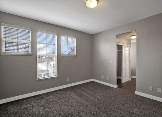 A room with grey walls and a carpeted floor.