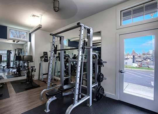 A gym with a view of a street outside the window.