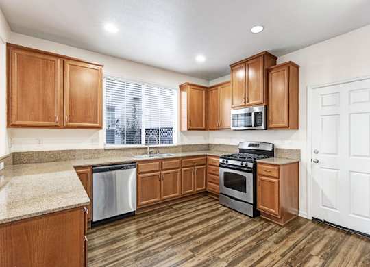 A kitchen with wooden cabinets and a white door.