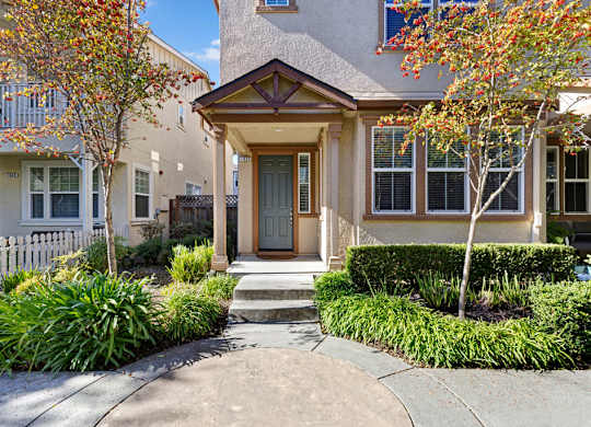 A house with a brown front door and a small porch.