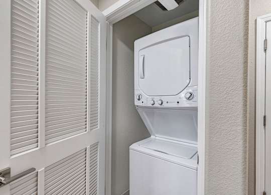 A white oven and microwave are installed in a small kitchen.