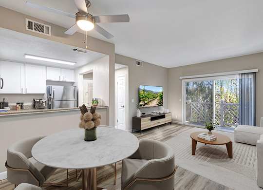 A modern living room with a dining table and chairs.