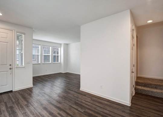 A room with wooden floors and white walls.