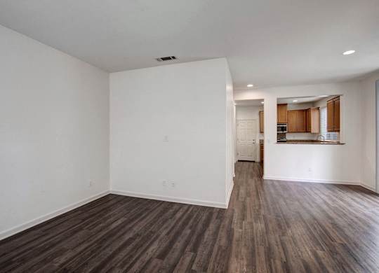 A room with wooden floors and white walls.