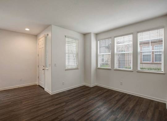A room with wooden floors and white walls.