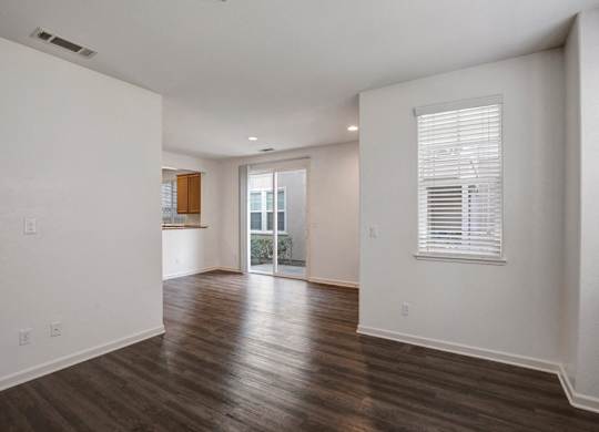A room with wooden floors and white walls.