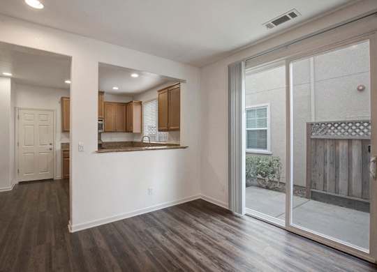 A room with wooden floors and a large mirror on the wall.
