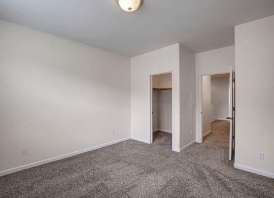 A room with carpeted floor and white walls.