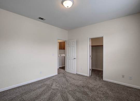 A room with a carpeted floor and a ceiling light.