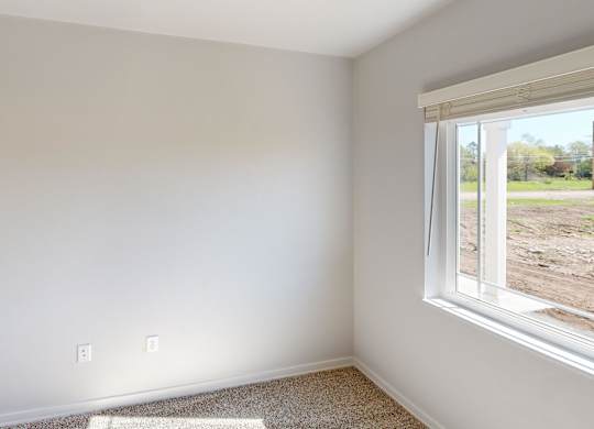 A room with a window overlooking a construction site.