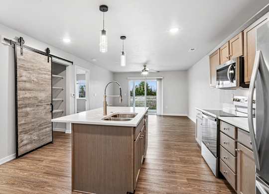 A modern kitchen with wooden cabinets and a large island.